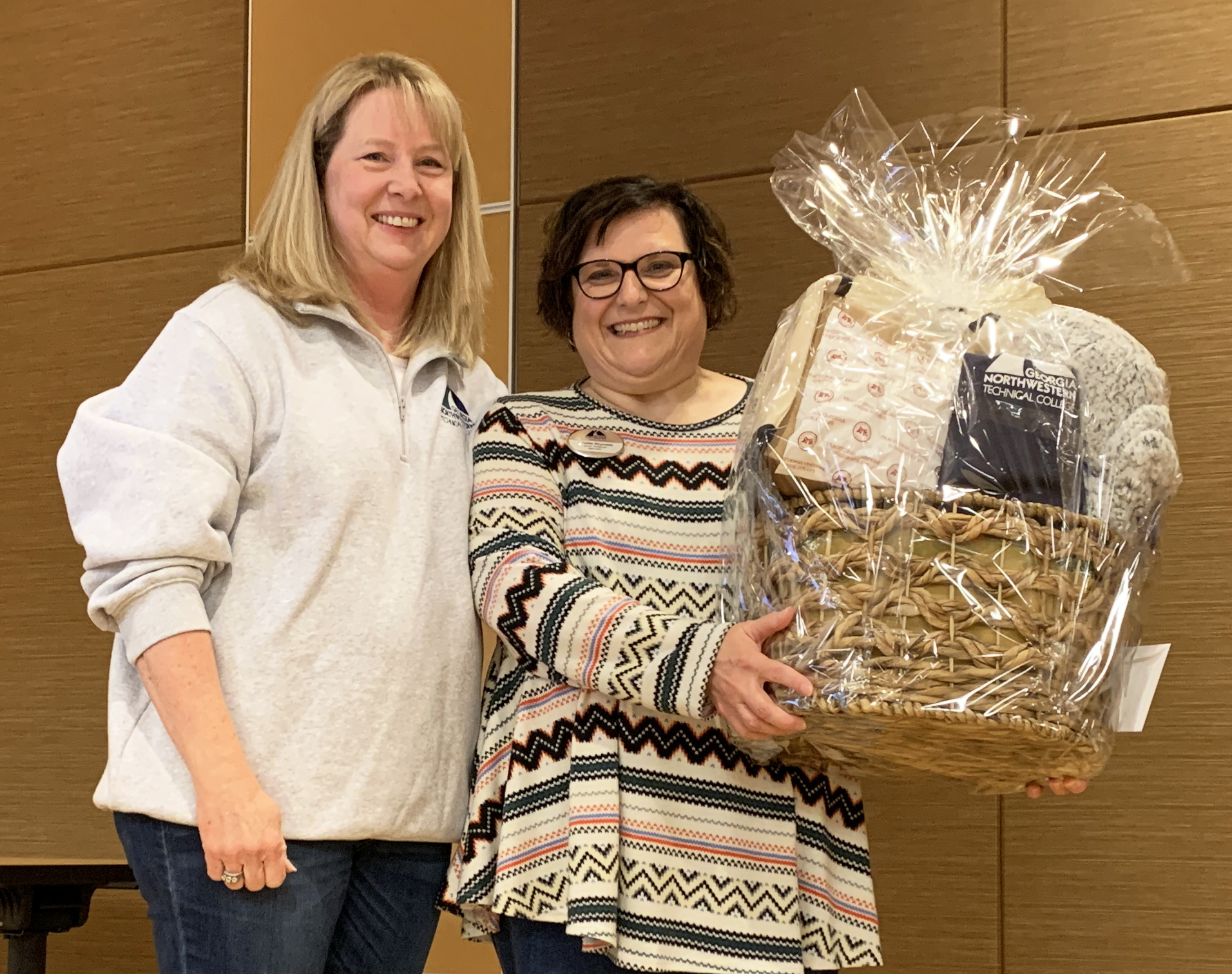 Dr. Heidi Popham, app president (left), presents Jennifer Reynolds with a app gift basket in recognition of her selection as app’s 2024 Staff Member of the Year Award winner.