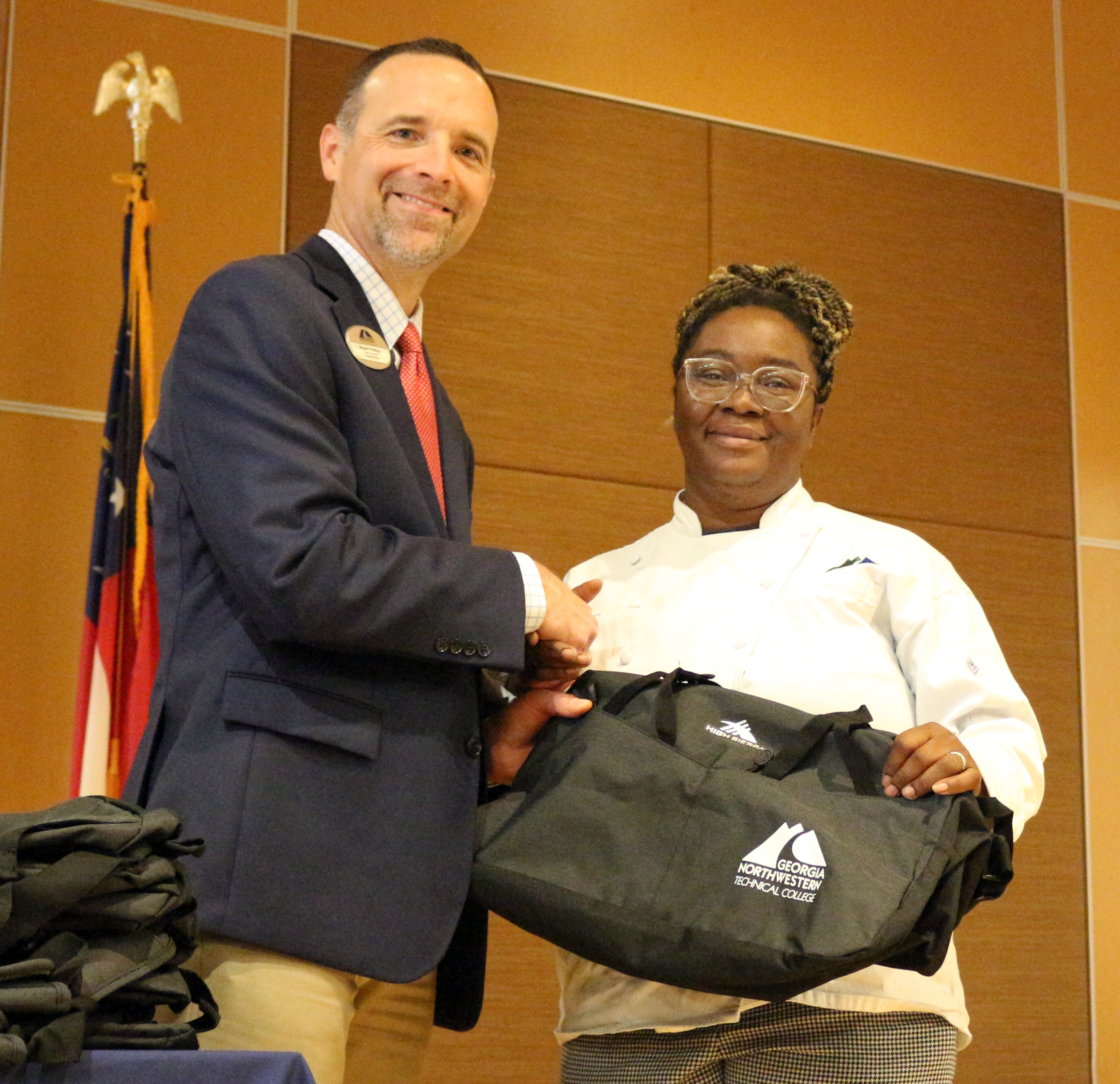 Stuart Phillips (left), vice president of Student Affairs at app, recognizes Stephanie Follins for representing app in Baking and Pastry Arts competition at the 2024 SkillsUSA Georgia State Leadership and Skills Conference.